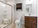 Full bathroom with a glass enclosed shower stall, wood vanity and open storage at 75 Springwood Ln, Franklinton, NC 27525