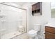 Full bathroom with a glass enclosed shower stall, wood vanity and open storage at 75 Springwood Ln, Franklinton, NC 27525