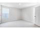 Bright bedroom with two windows and a white door at 75 Springwood Ln, Franklinton, NC 27525