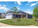 Charming single-Gathering home with a red front door, manicured lawn, and attached two-car garage at 75 Springwood Ln, Franklinton, NC 27525