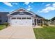 Attractive home featuring an attached garage, light blue vinyl siding, and manicured lawn at 75 Springwood Ln, Franklinton, NC 27525