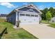 View of the garage and driveway area of this cute home, featuring a pristine concrete driveway at 75 Springwood Ln, Franklinton, NC 27525