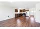 Open-concept kitchen featuring wooden cabinets, stainless steel appliances, and hardwood floors at 75 Springwood Ln, Franklinton, NC 27525