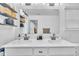 Bathroom vanity features double sinks, a large mirror, and storage shelves for added convenience at 81 Paperwhite Pl # 213, Clayton, NC 27527