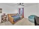 Cozy bedroom featuring a daybed, beanbag chair, and a bookshelf with books and toys at 81 Paperwhite Pl # 213, Clayton, NC 27527