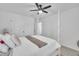 Bright bedroom with a four-poster bed, ceiling fan, and a door to another room at 81 Paperwhite Pl # 213, Clayton, NC 27527