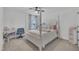 Bright bedroom with four-poster bed, ceiling fan, and a window with neighborhood views at 81 Paperwhite Pl # 213, Clayton, NC 27527