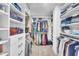 Large walk-in closet with custom shelving, drawers, and hanging rods at 81 Paperwhite Pl # 213, Clayton, NC 27527