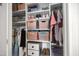 Organized walk-in closet with shelves, hanging rods, and storage bins at 81 Paperwhite Pl # 213, Clayton, NC 27527