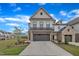 Two-story home with brick and siding, showcasing a well-manicured lawn and an attached two car garage at 81 Paperwhite Pl # 213, Clayton, NC 27527