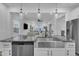 Kitchen with stainless steel sink, modern faucet, dishwasher, and an open concept view to the living room at 81 Paperwhite Pl # 213, Clayton, NC 27527