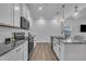 Modern kitchen featuring white cabinets, granite countertops, subway tile backsplash, and stainless steel appliances at 81 Paperwhite Pl # 213, Clayton, NC 27527