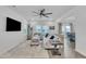 Bright living room features hardwood floors, neutral furniture, modern decor, and seamless flow to the dining area at 81 Paperwhite Pl # 213, Clayton, NC 27527