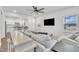 Stylish living room featuring hardwood floors, modern furniture, and seamless transition to the well-lit kitchen at 81 Paperwhite Pl # 213, Clayton, NC 27527