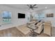 Bright living room features hardwood floors, neutral furniture, modern decor, and seamless flow to the dining area at 81 Paperwhite Pl # 213, Clayton, NC 27527