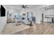 Bright living room features hardwood floors, neutral furniture, modern decor, and seamless flow to the dining area at 81 Paperwhite Pl # 213, Clayton, NC 27527