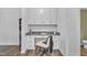 Modern office area with built-in cabinets, black marble countertop, a chair, and wood-look floors at 81 Paperwhite Pl # 213, Clayton, NC 27527