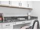 Office space featuring white cabinetry, black marble countertop, and modern desk accessories at 81 Paperwhite Pl # 213, Clayton, NC 27527
