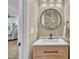 Stylish powder room with vanity, round mirror, and floral wallpaper at 81 Paperwhite Pl # 213, Clayton, NC 27527