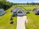 Aerial shot of a home with a spacious lot, a driveway, and a three-car garage at 834 Mamie Upchurch Rd, Lillington, NC 27546