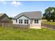 Back exterior showing windows and fenced backyard at 834 Mamie Upchurch Rd, Lillington, NC 27546