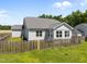 Exterior view of the back of the home with a fenced backyard at 834 Mamie Upchurch Rd, Lillington, NC 27546