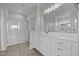 Bright bathroom featuring a glass enclosed shower, dual sinks, and white cabinets and countertops at 834 Mamie Upchurch Rd, Lillington, NC 27546