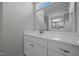 Bright bathroom featuring sink and vanity with white marble countertops and oversized mirror at 834 Mamie Upchurch Rd, Lillington, NC 27546