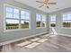 Bedroom with beautiful hardwood floors and large windows showcasing the backyard at 834 Mamie Upchurch Rd, Lillington, NC 27546