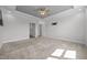 Spacious bedroom featuring neutral carpet, tray ceiling with fan, and bracket for mounting a television at 834 Mamie Upchurch Rd, Lillington, NC 27546