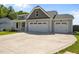 Exterior view showcasing a home's three-car garage and well-maintained landscaping at 834 Mamie Upchurch Rd, Lillington, NC 27546
