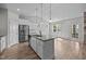 Spacious kitchen with granite island, stainless steel appliances, and white cabinetry at 834 Mamie Upchurch Rd, Lillington, NC 27546