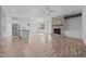 Open living space with stainless steel appliances, kitchen island, and stone fireplace at 834 Mamie Upchurch Rd, Lillington, NC 27546