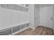 Mudroom with a white bench with shelving and a door on the right at 834 Mamie Upchurch Rd, Lillington, NC 27546