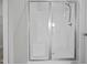 Walk-in shower featuring glass doors and a built in seat at 834 Mamie Upchurch Rd, Lillington, NC 27546