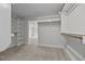 Large walk-in closet featuring built-in shelving and rods for storage, with an open doorway to the bedroom at 834 Mamie Upchurch Rd, Lillington, NC 27546