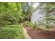 The backyard features a stone path and lush greenery, offering a peaceful outdoor retreat at 8605 Stanton Pl, Raleigh, NC 27615
