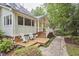 Backyard view of home featuring a wooden deck, chairs and stone pathway at 8605 Stanton Pl, Raleigh, NC 27615