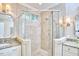 A bathroom featuring a corner glass shower, granite countertops, and double sinks at 8605 Stanton Pl, Raleigh, NC 27615