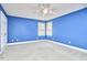 A blue bedroom featuring neutral carpet and a double window at 8605 Stanton Pl, Raleigh, NC 27615