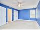 A blue bedroom featuring neutral carpet and a double window and a closet at 8605 Stanton Pl, Raleigh, NC 27615