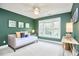 Bedroom with green walls, natural light, a ceiling fan, and a daybed at 8605 Stanton Pl, Raleigh, NC 27615