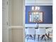 Dining room with blue walls and hardwood floors as viewed from the hallway, featuring a light fixture at 8605 Stanton Pl, Raleigh, NC 27615