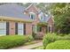 Charming brick home with manicured front yard and lush landscaping at 8605 Stanton Pl, Raleigh, NC 27615