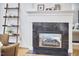 Close-up of black marble fireplace with white mantle and hearth, and a decorative ladder shelf nearby at 8605 Stanton Pl, Raleigh, NC 27615