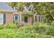 Charming brick home featuring an arched entrance with lush greenery and manicured landscaping at 8605 Stanton Pl, Raleigh, NC 27615