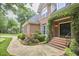 Elegant brick home with an inviting entrance adorned with climbing vines and brick steps at 8605 Stanton Pl, Raleigh, NC 27615