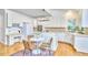 Bright kitchen with white cabinets and dining table at 8605 Stanton Pl, Raleigh, NC 27615