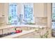 Close up of sink in bright kitchen with white cabinets and backsplash at 8605 Stanton Pl, Raleigh, NC 27615