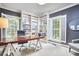 Well-lit office with built-in shelves, a modern desk, a comfortable chair, and plantation shutters at 8605 Stanton Pl, Raleigh, NC 27615